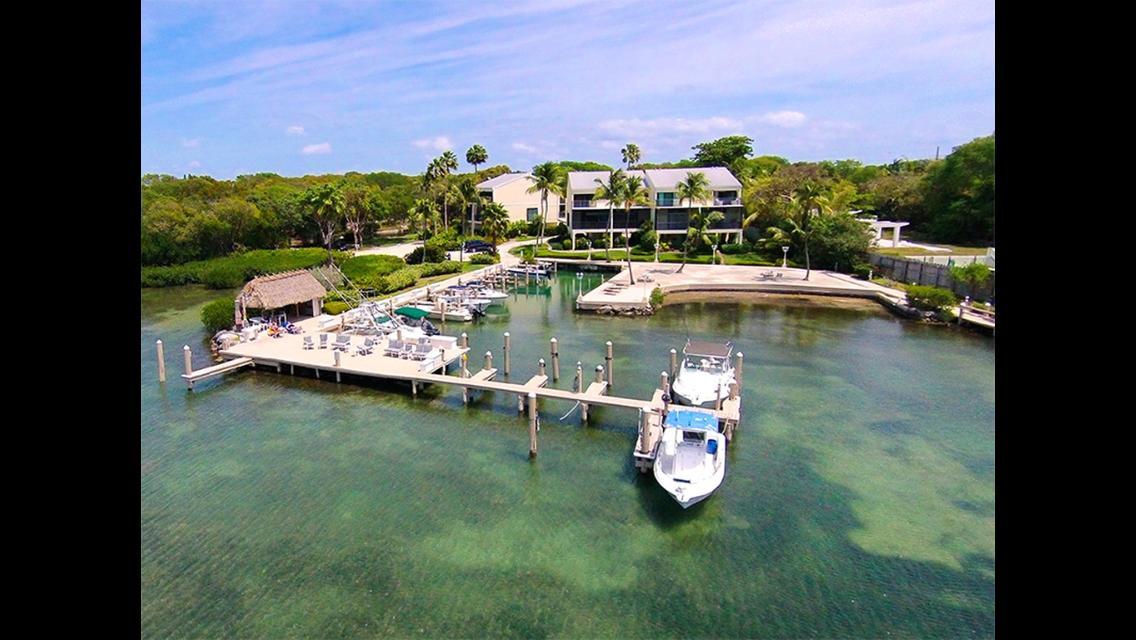 Aerial view of waterfront condominium community in the Florida Keys with boat dockage